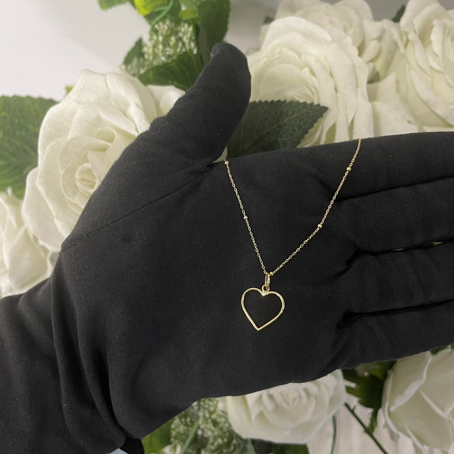 Collana rollò e sfere con cuore forato oro